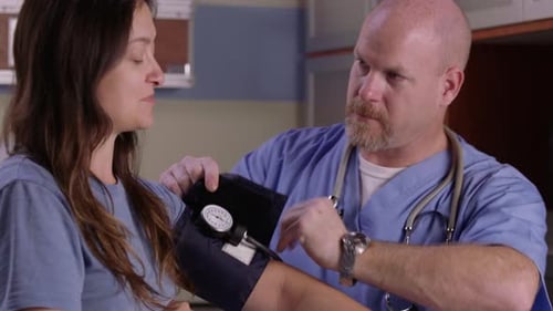Doctor Measuring Blood Pressure on Woman's Arm