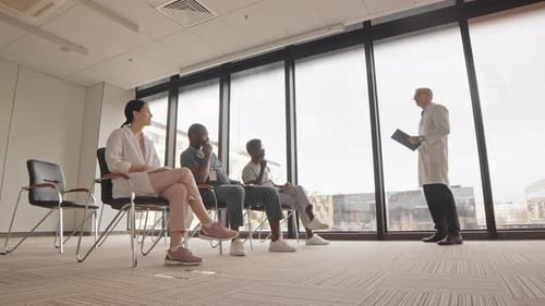 Medical Professional Giving Presentation to Colleagues in Office