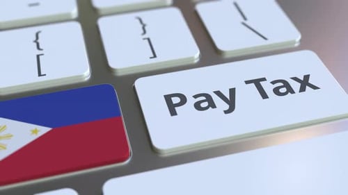 PAY TAX Texte et drapeau des Philippines sur le clavier