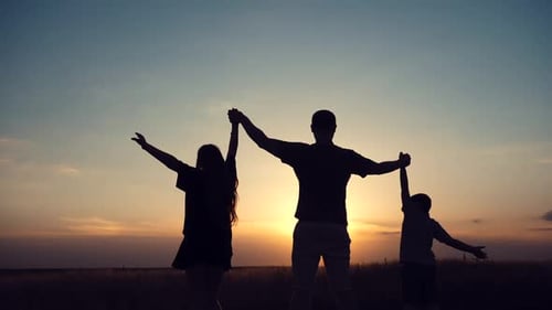 Happy family: father, children son and daughter on nature on sunset