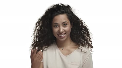 Closeup of Flirty Darkskinned Woman with Long Curly Hair Flicking Finger to Invite Someone Asking to