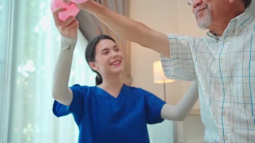 Therapist Assists Senior Man with Arm Exercises