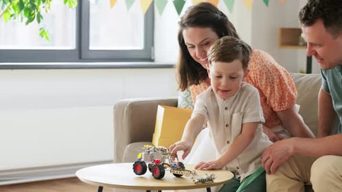 Happy Family Playing with Toy Vehicle at Home