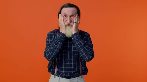 Senior Man Reacts with Surprise and Wide Eyes