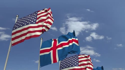 United States and Iceland Flags Waving in Blue Sky