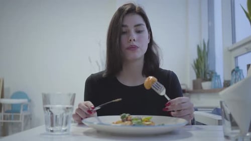 Portrait of a Pretty Young Brunette Girl Eating in a Beautiful Restaurant or Cafe