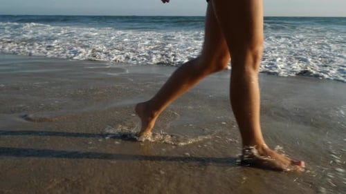 Attractive woman walking along the beach in Southern California