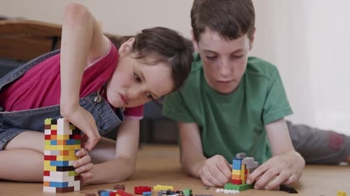Children Building Colorful Towers with Blocks at Home