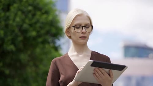 Woman Using Tablet in Urban Environment