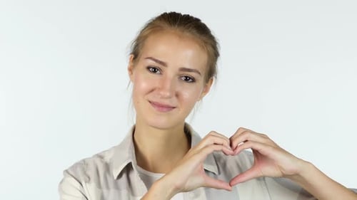 Smiling Woman Makes Heart Shape with Hands