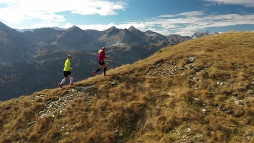 Aerial View Trail Running Couple in Mountains