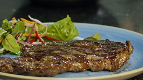 Grilled Steak Served with Salad on Blue Plate