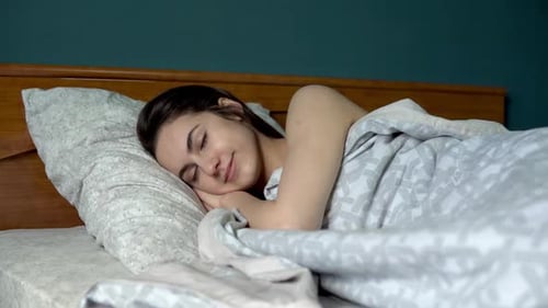 Woman Sleeping Peacefully in Bed at Home