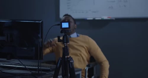 Man in Wheelchair Recording Video in Office