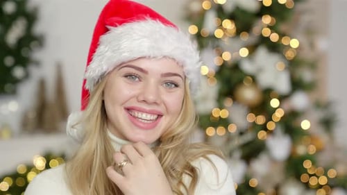 Woman in Santa Hat Smiling at Christmas