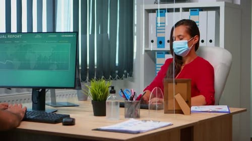 Woman in Mask Working at Desk in Office