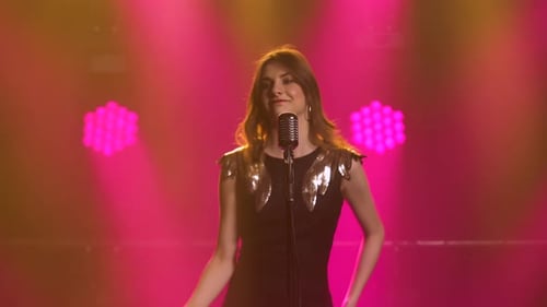 Glamorous Singer Performing with Retro Microphone on Stage