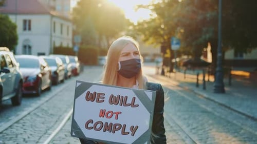 Protest Walk Woman in a Medical Mask Holding Placard with Words That People Won't Comply