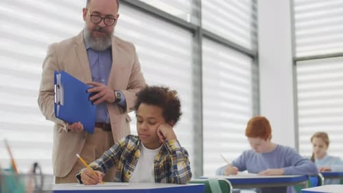 Teacher Helping Student in Classroom, Close Up