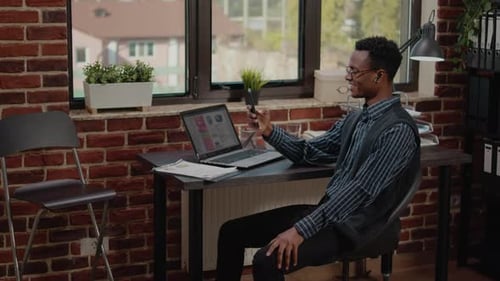 Young Adult Video Call in Modern Brick Office
