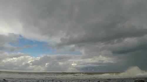 Stormy Waves Breaking on Sandy Coast Foretelling Trouble and Bad Weather