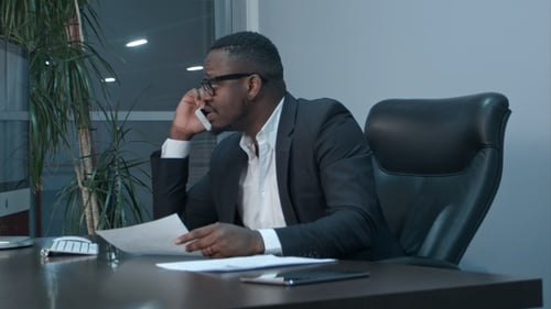 Professional Man Talking on Phone at Desk