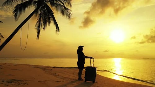 Pretty happy lady on vacation spending quality time at the beach on paradise white sand and blue 4K
