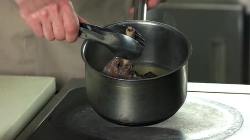Chef Cooking a Bone in Steaming Water