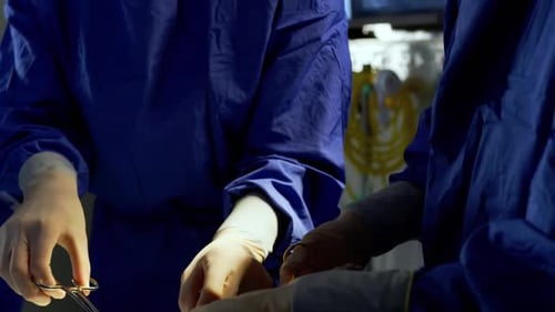 Surgeons Performing Delicate Operation in Hospital Operating Room