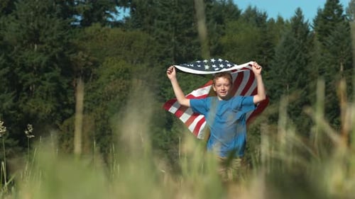 Boy Runs with American Flag in Field