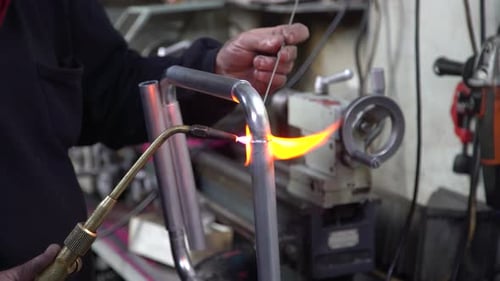Welding Torch on Metal Frame in Workshop