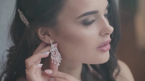 Woman Puts on Elegant Crystal Chandelier Earring