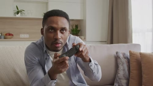 Enthusiastic Man Plays Video Games at Home