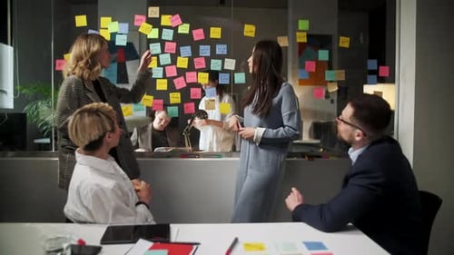 Team Meeting With Sticky Notes in Modern Office