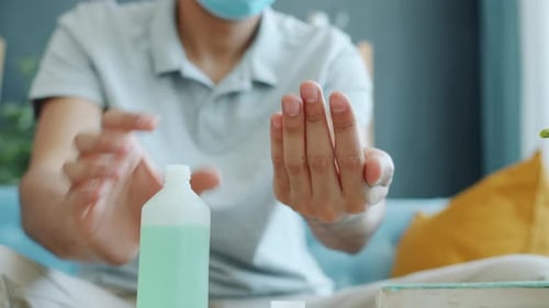Close-up of Male Hands Using Sanitizer at Home Washing Palms Carefully
