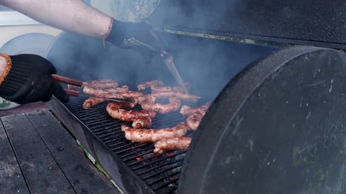 Sausages Grilling on a Charcoal Barbecue Grill