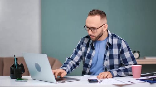 Focused Trendy Handsome Man Working Use Laptop at Modern Office