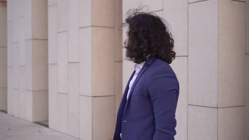 A Male Businessman is Waiting Outside and Looking at His Watch