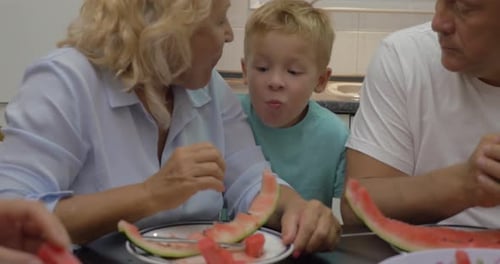 Blonde Family Eating Fresh Watermelon Together
