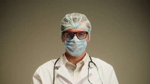 Doctor Wearing Mask and Surgical Cap Close Up