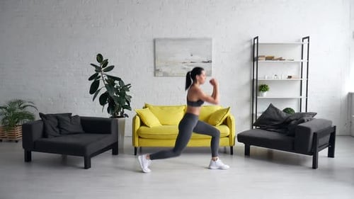 Athletic Woman Doing Lunges in Bright Living Room
