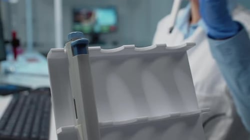 Close Up of Hand Using Micropipette in Science Laboratory