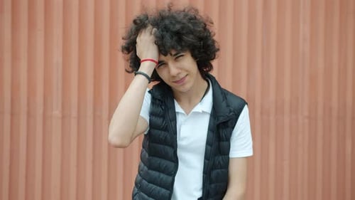 Teen Boy Posing and Running Hand Through Hair