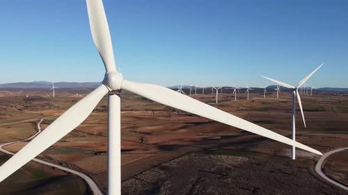 Windmills in field on sunny day
