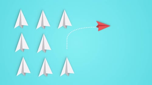 Group of the white paper planes and one different color