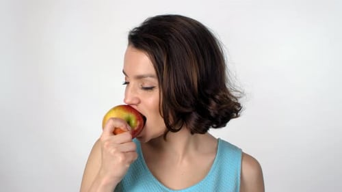 Portrait of Beautiful Woman Biting Apple