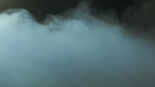 White Smoke Flowing on Black Background