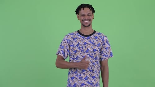 Young Man Giving Thumbs Up on Green Screen