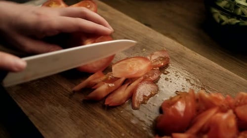 Slicing Fresh Red Tomatoes on Cutting Board