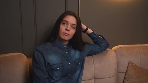 Portrait of Upset Tired Woman Sitting on Couch at Home